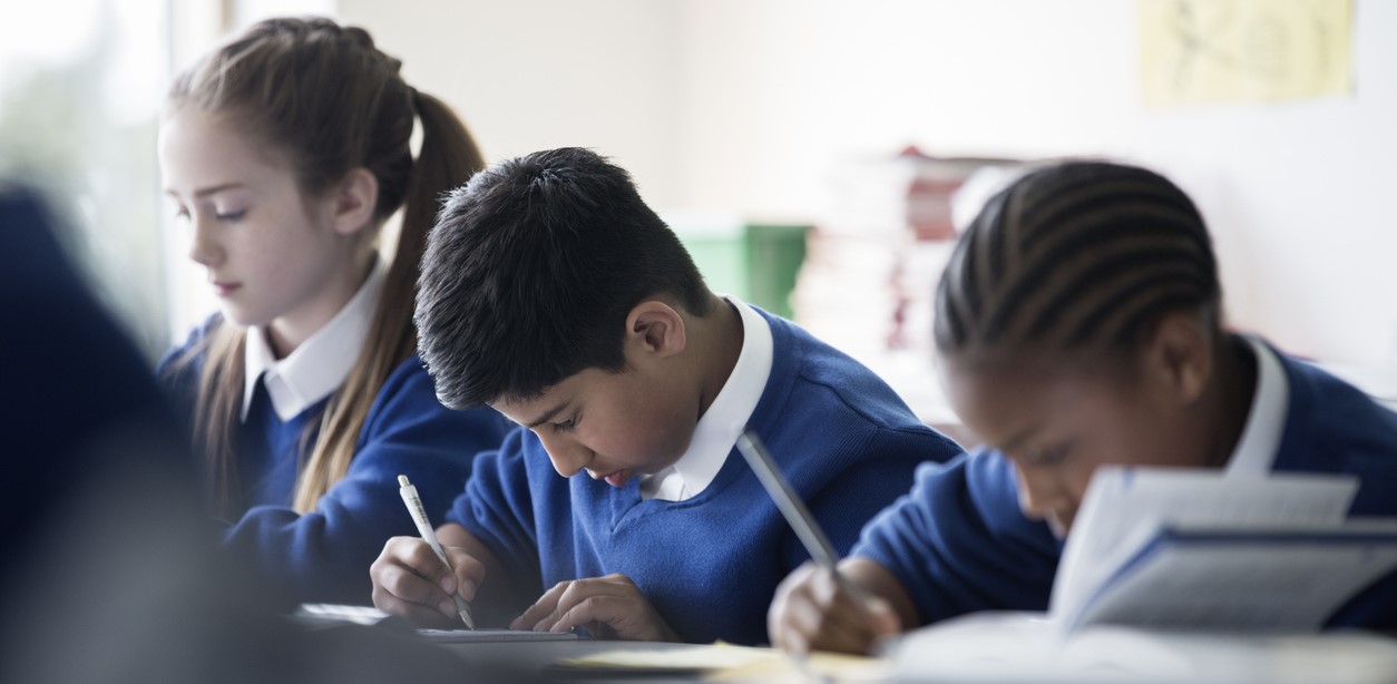 Students writing for peer assessment task in class